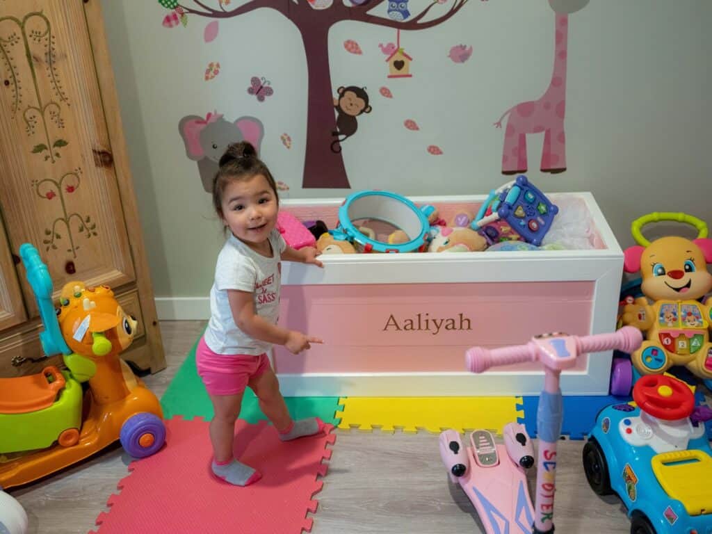 Aaliyah points to her toy box crafted by Doug Eckerty, the executive director of JobSource, which runs Anderson Scholar House. (Maxine Wallace for Chalkbeat)