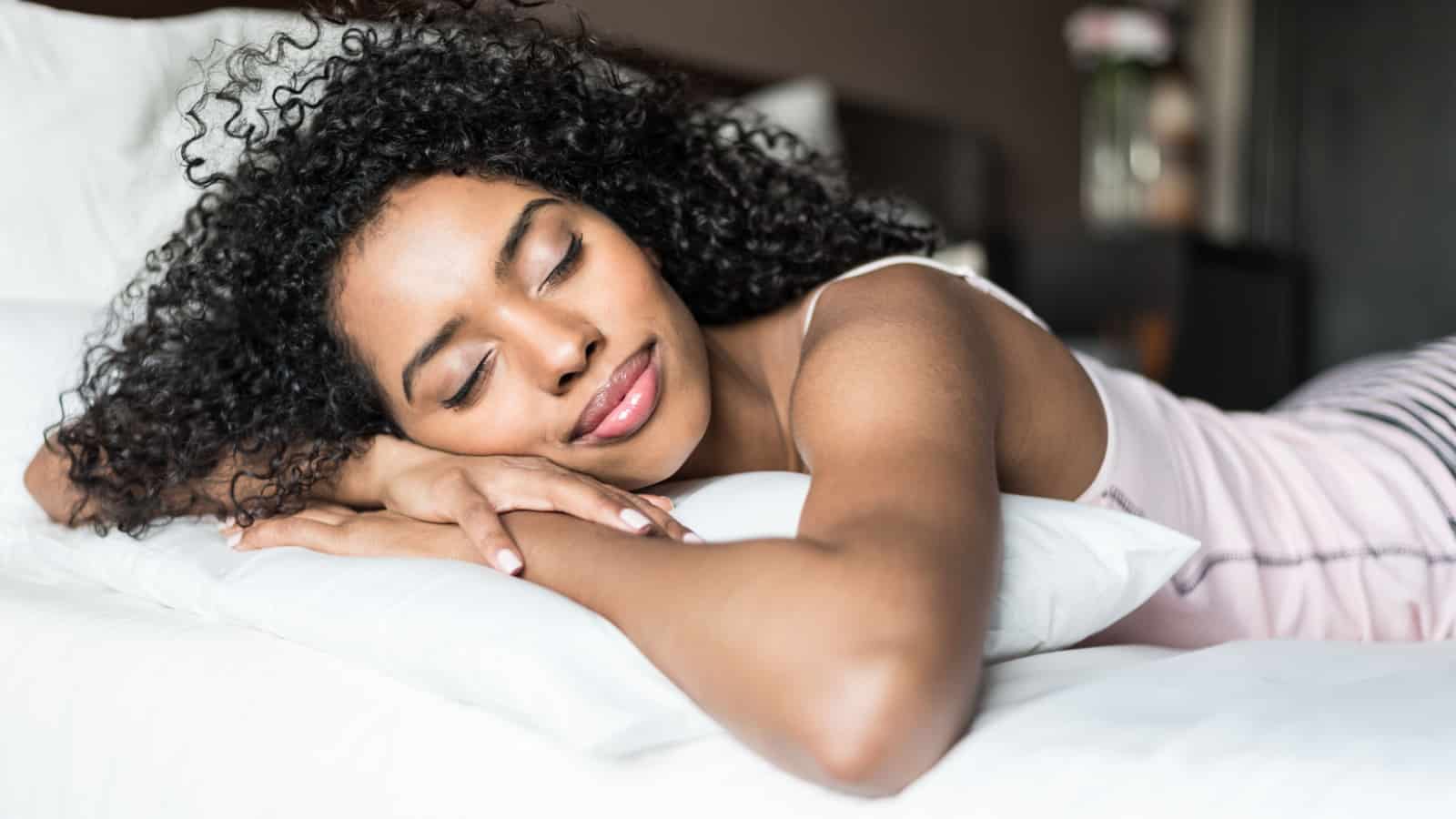 Beautiful black woman getting a good night's sleep.