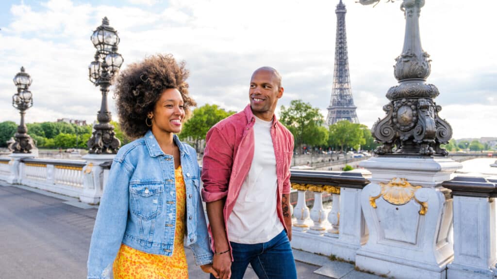 Couple holding hands in Paris.