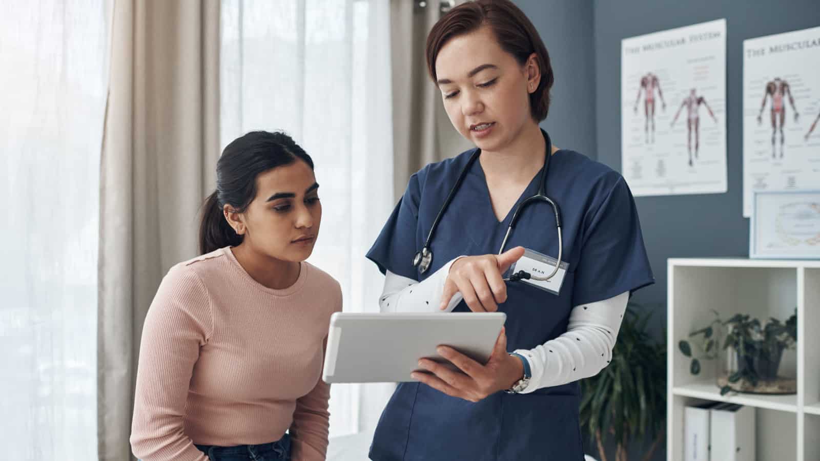 Doctor or dietitian speaking with female patient.