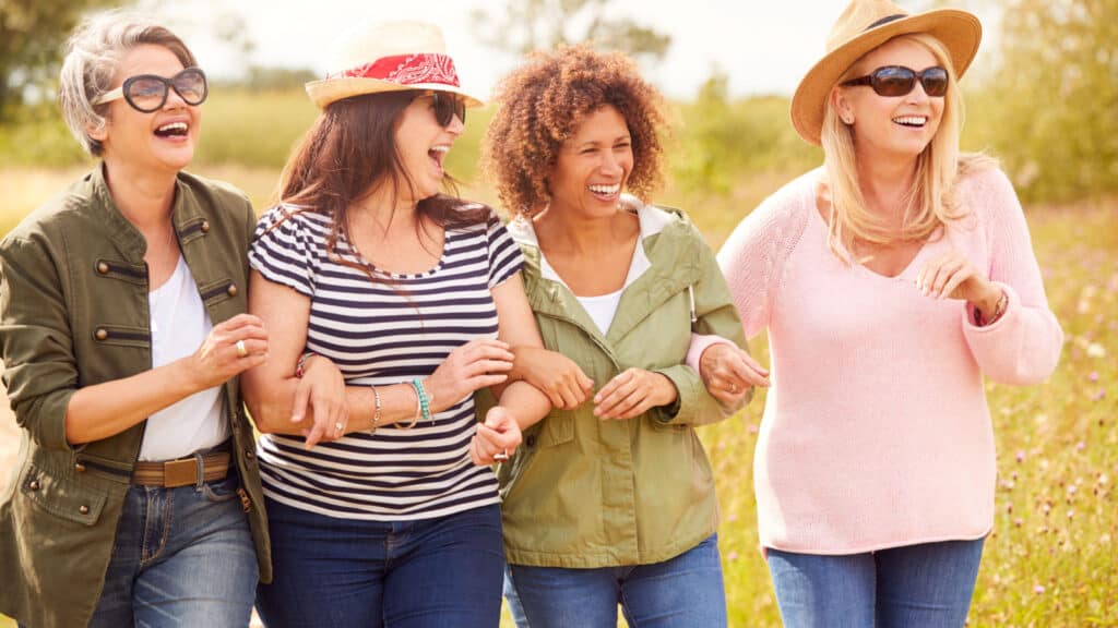 Group of women walking together. Smiling.