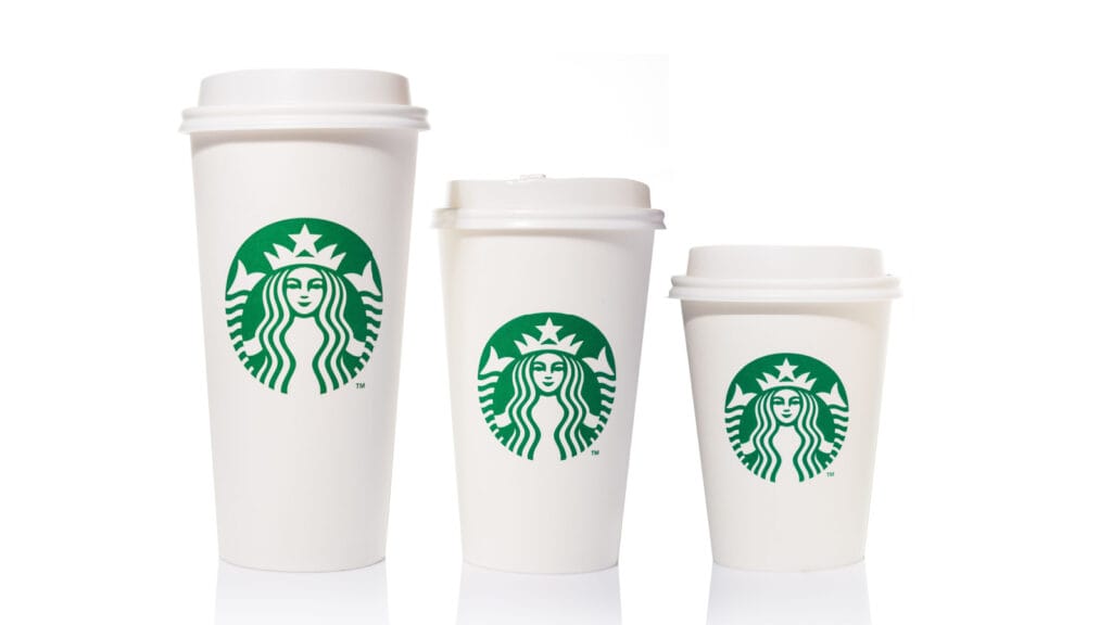 Three sizes of Starbucks coffee cups.