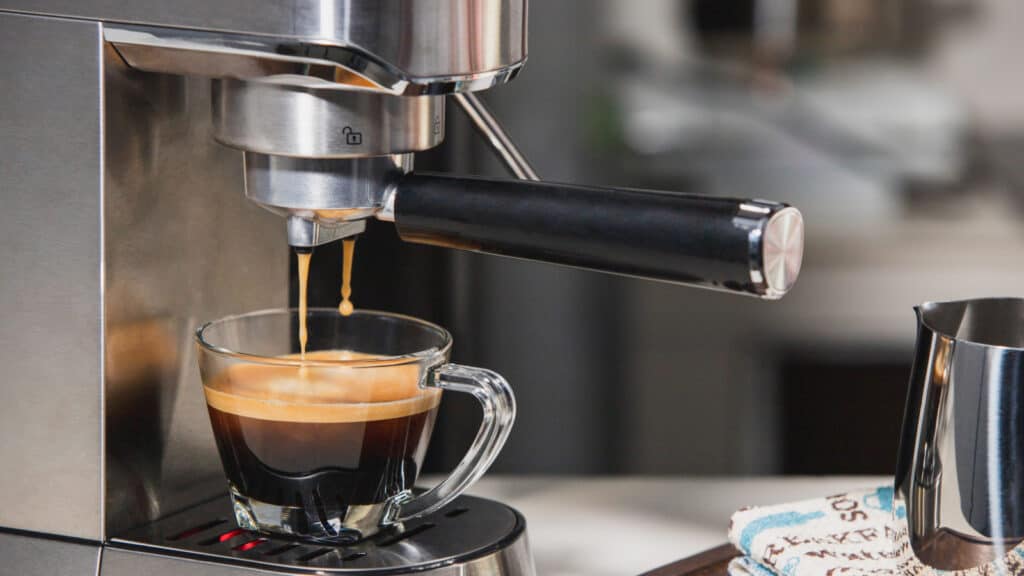 Espresso machine making espresso in a glass cup.