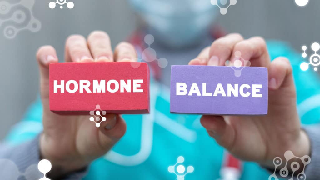Hands holding blocks with words: hormone balance.