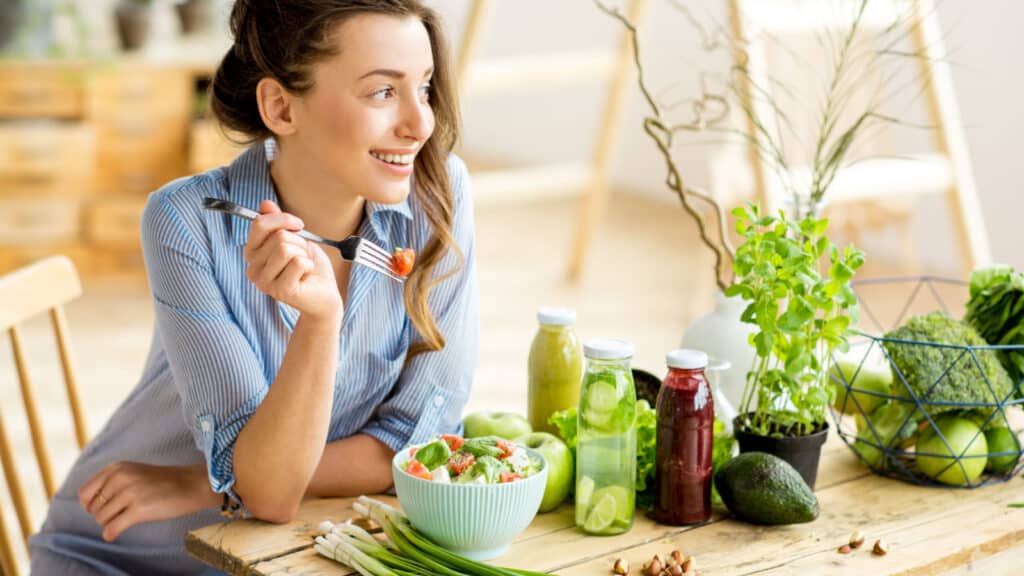 Young woman eating a salad.