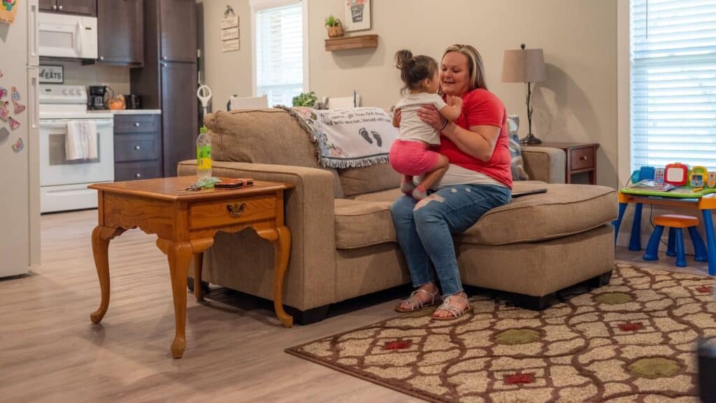 Amanda Lowery and her daughter Aaliyah in their apartment at the Anderson Scholar House. The program helps single mothers attain a college degree while securing housing. (Maxine Wallace for Chalkbeat)