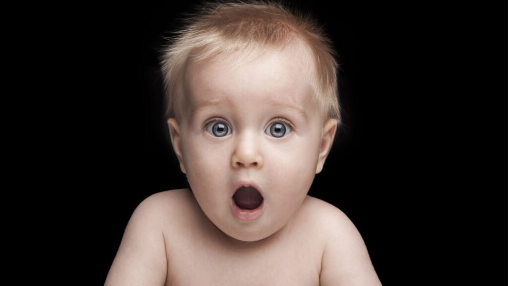 Naked baby looking surprised. Shocked. 