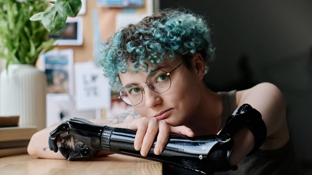 Young girl with prosthetic arm. Nonbinary. Woman