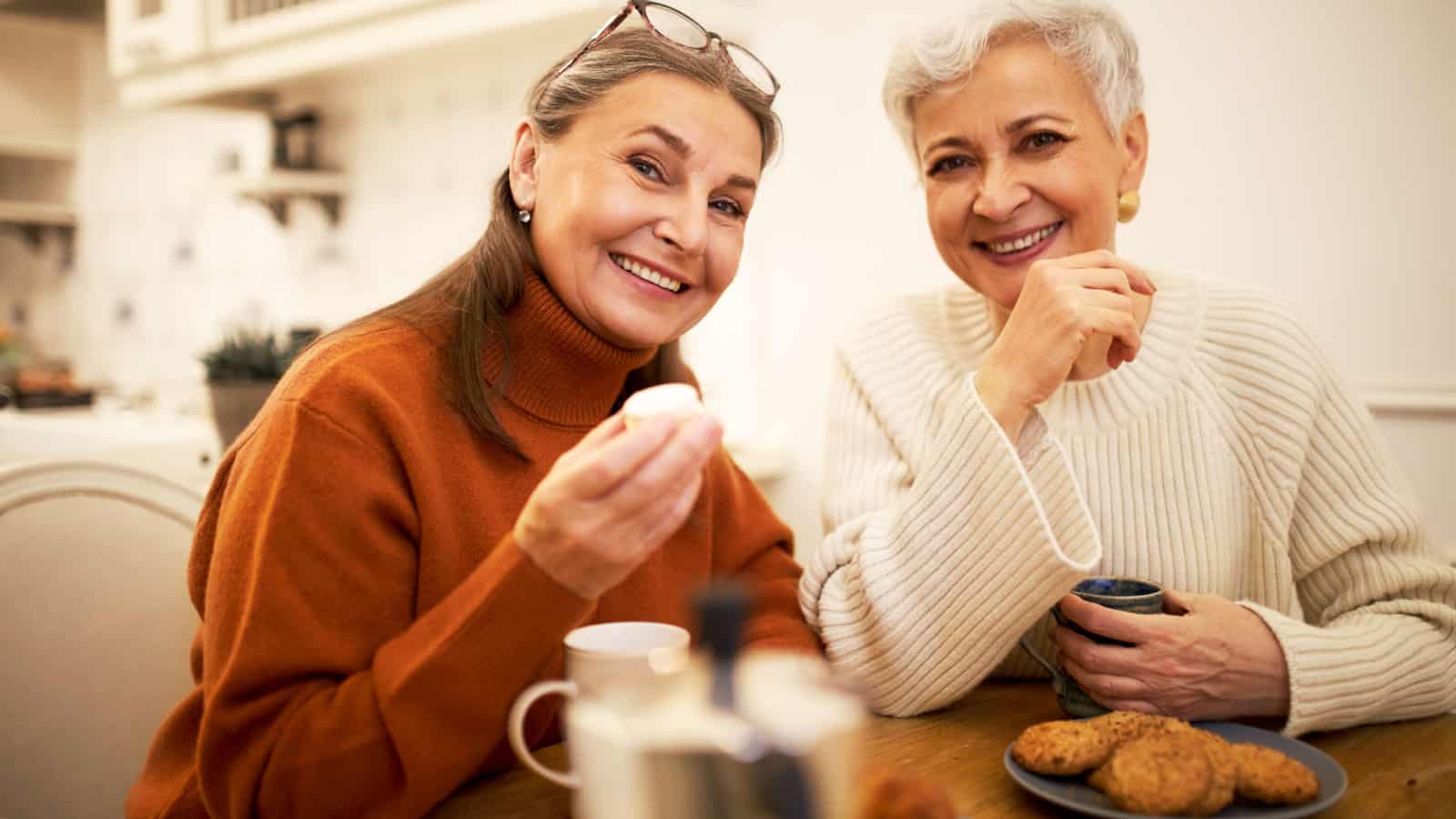 Two senior older women sharing a meal.
