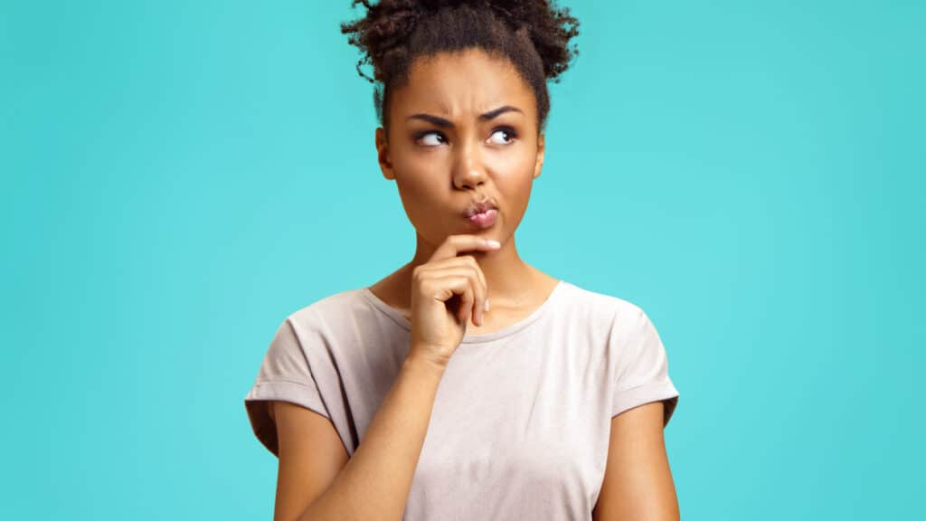 Woman of color deep in thought. Questioning.