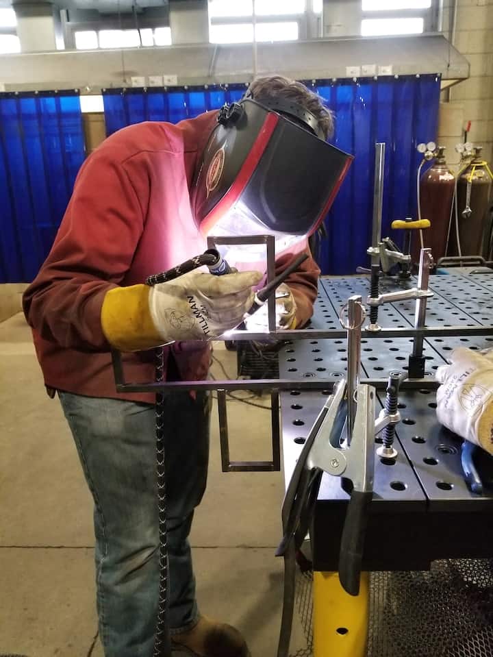 One of Kim Rosenbaum’s welding student works on a project for a local church. (Courtesy of Kim Rosenbaum and Chalkbeat)
