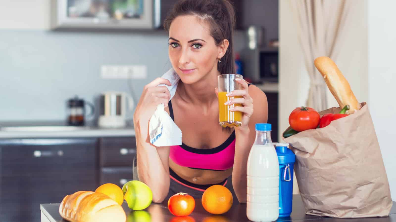 woman looking at camera with healthy food all around.