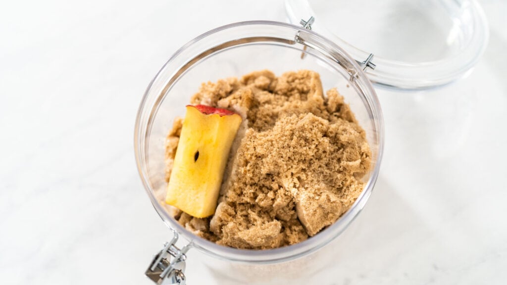 Brown sugar in container with piece of apple. Softening brown sugar. 