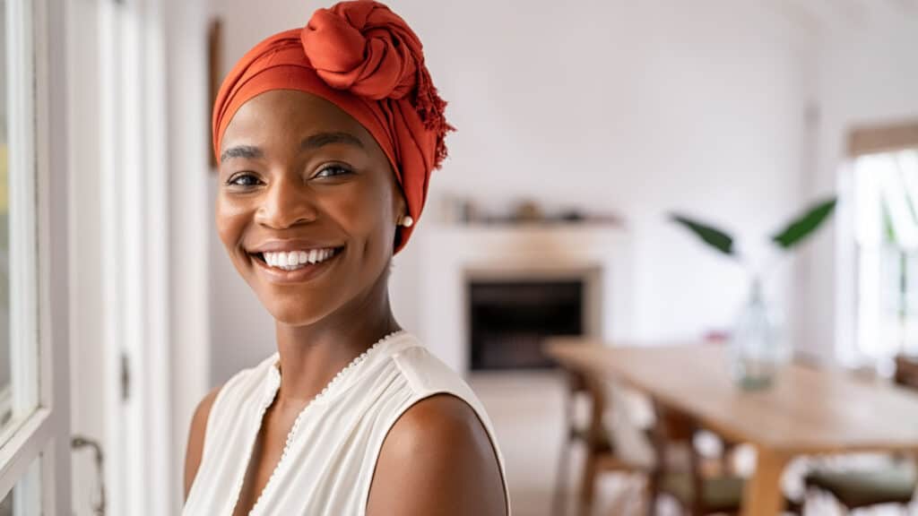 Confident stylish black woman in turban. Smiling woman.