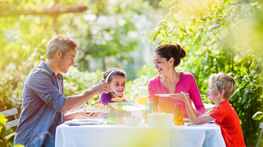 Family eating outside together. Outdoors.