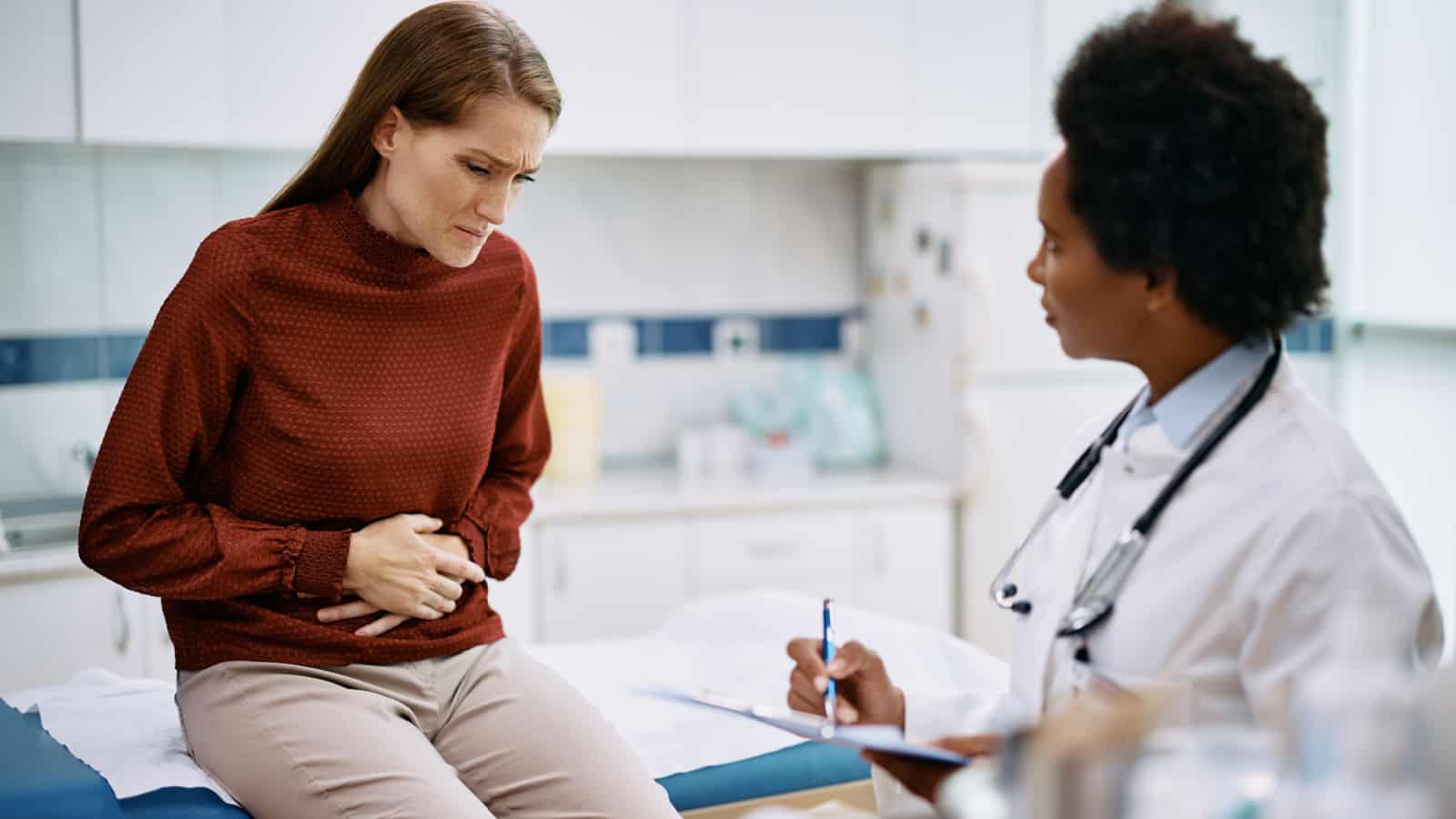 Female patient female doctor pain in abdomen.