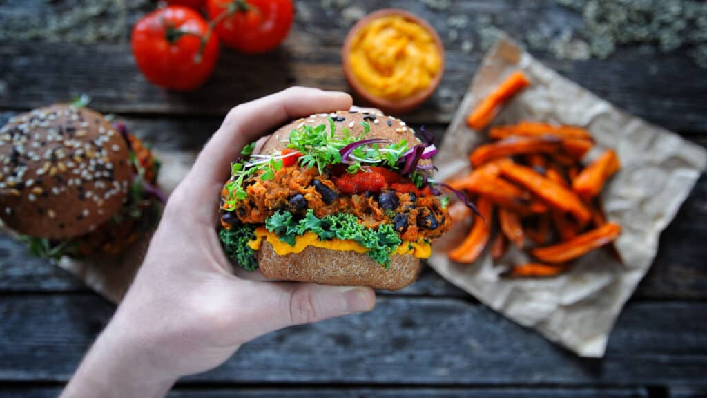 Hand holding veggie burger. 