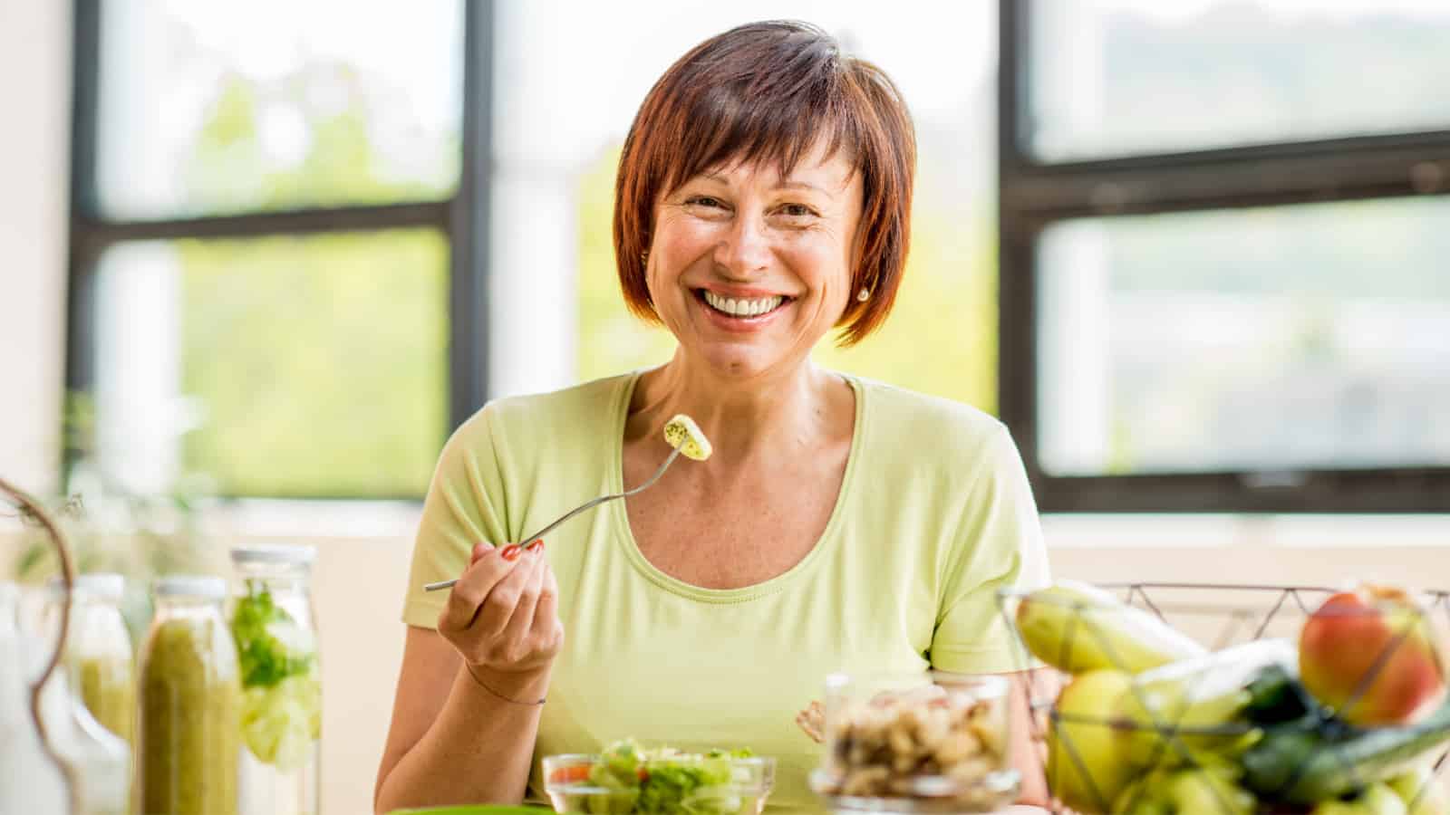 Happy older woman eating.