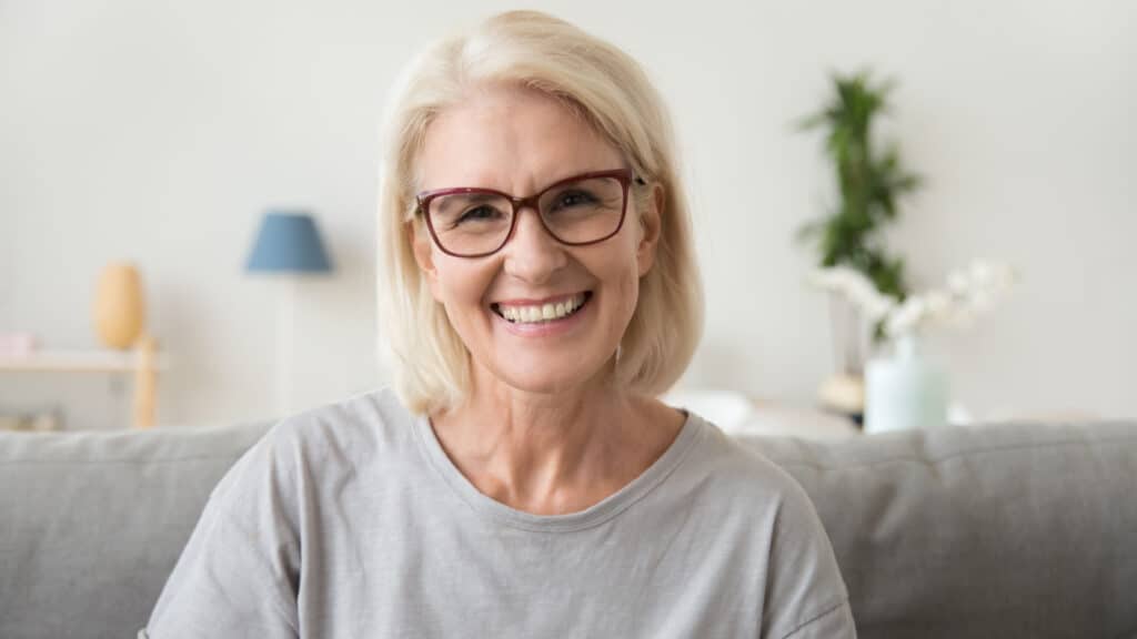 Happy woman wearing glasses.