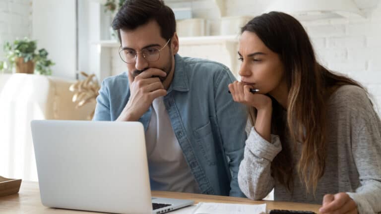 Man and woman looking at laptop.
