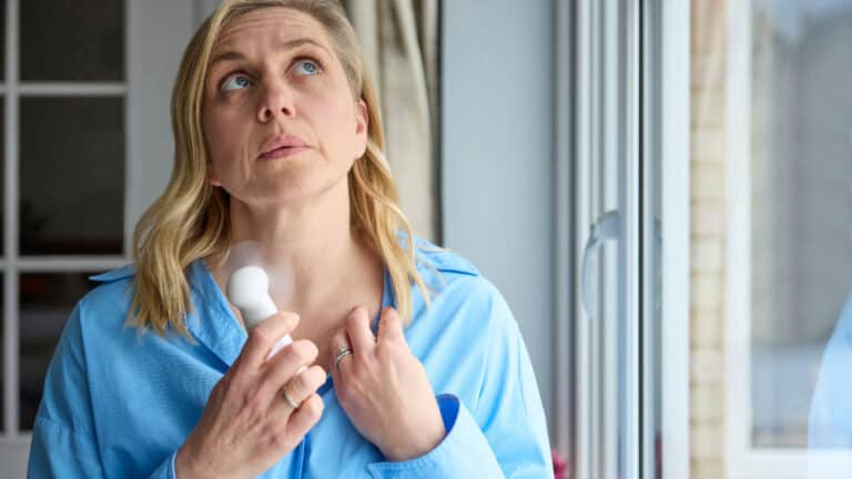 Older woman having hot flashes. Menopause.