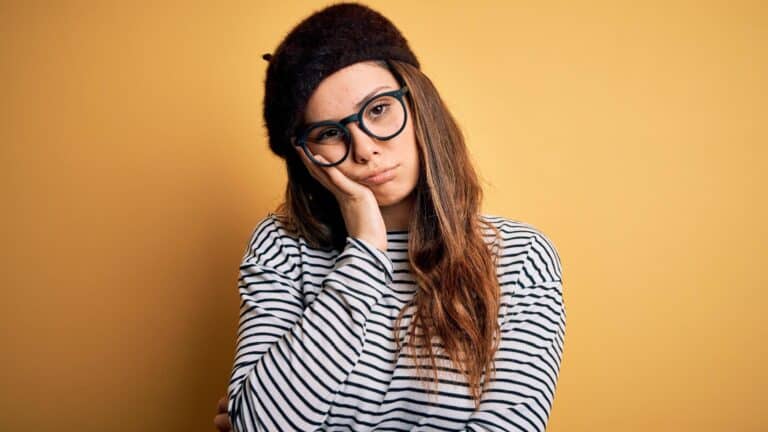 Sad young woman in beret.