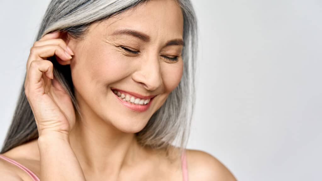 Smiling woman with gray hair. 