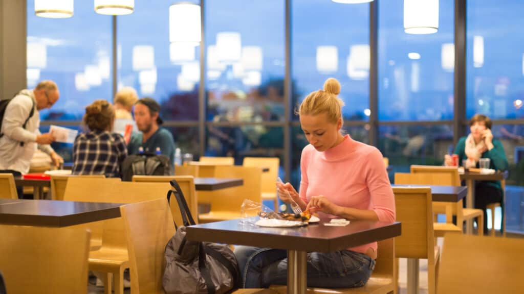 Woman eating in airport. 