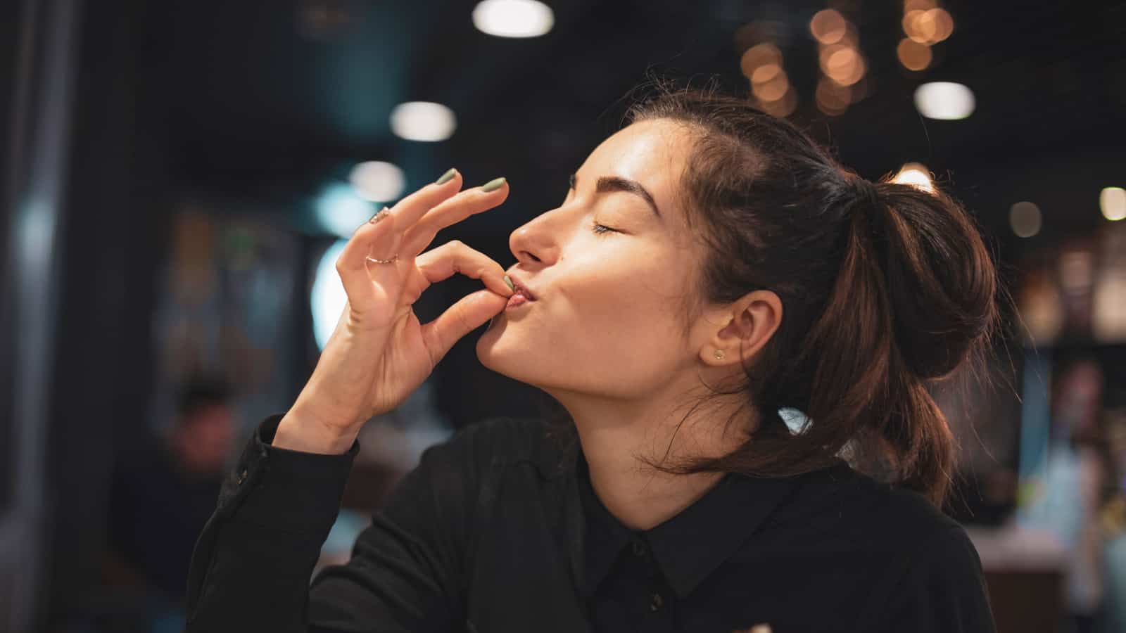 Woman giving a chef's kiss.