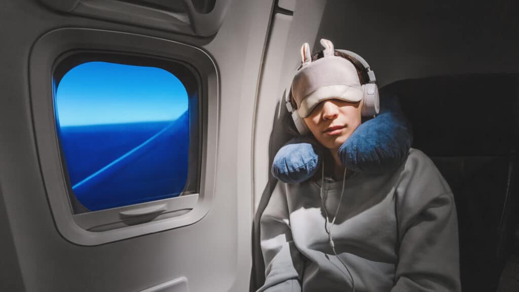 Woman sleeping on plane at night.