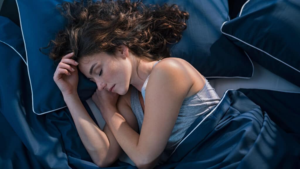 Woman sleeping peacefully in bed.