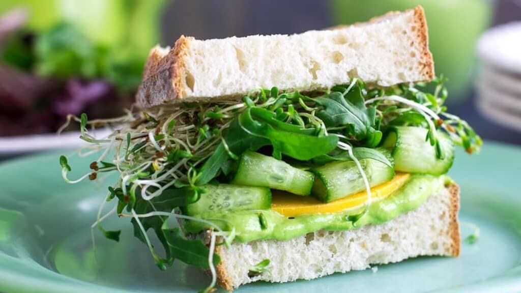 closeup-VEGAN-Low-FODMAP-Avocado-Green-Goddess-Veggie-Sandwich-on-green-plate.
