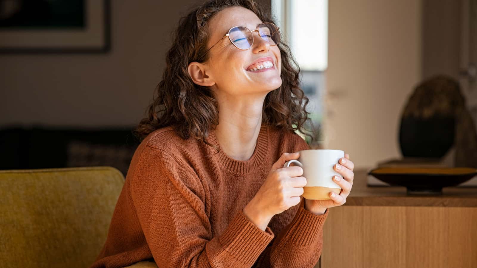 Happy smiling woman, female, girl, holding a cup of coffee.