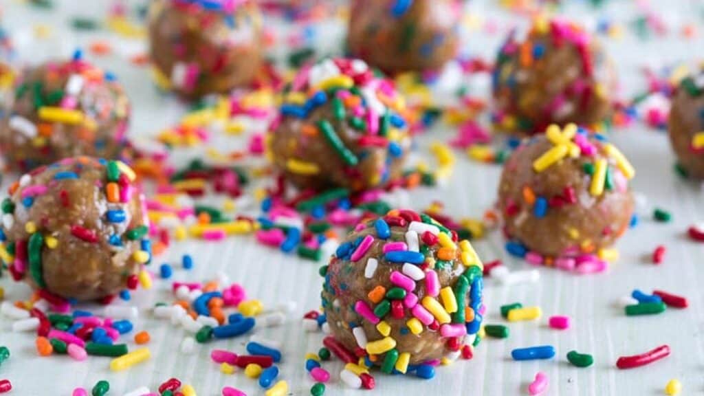 Birthday-Cake-Balls-on-pale-surface-with-sprinkles-all-over.