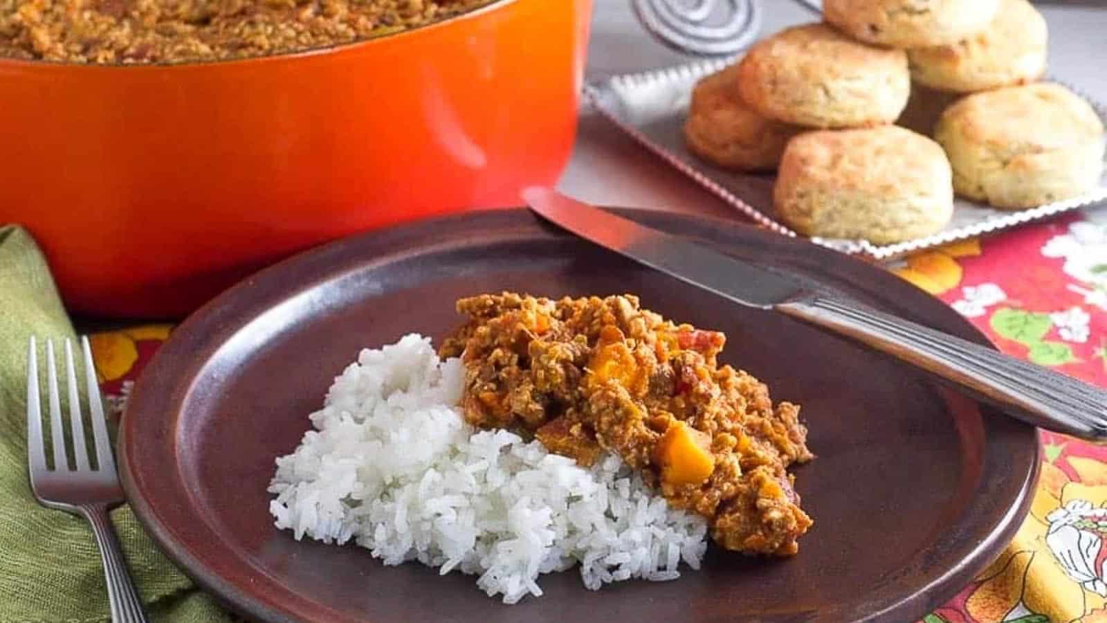 low-FODMAP-vegan-tempeh-chili-with-butternut-squash-on-brown-plate-with-rice.