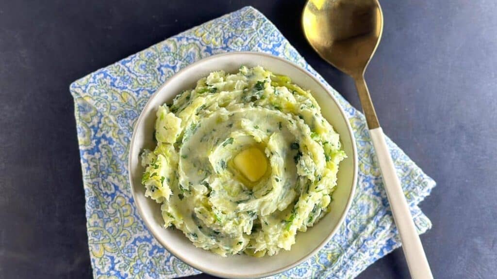 main-image-of-Low-FODMAP-Colcannon-in-white-bowl-with-gold-spoon.