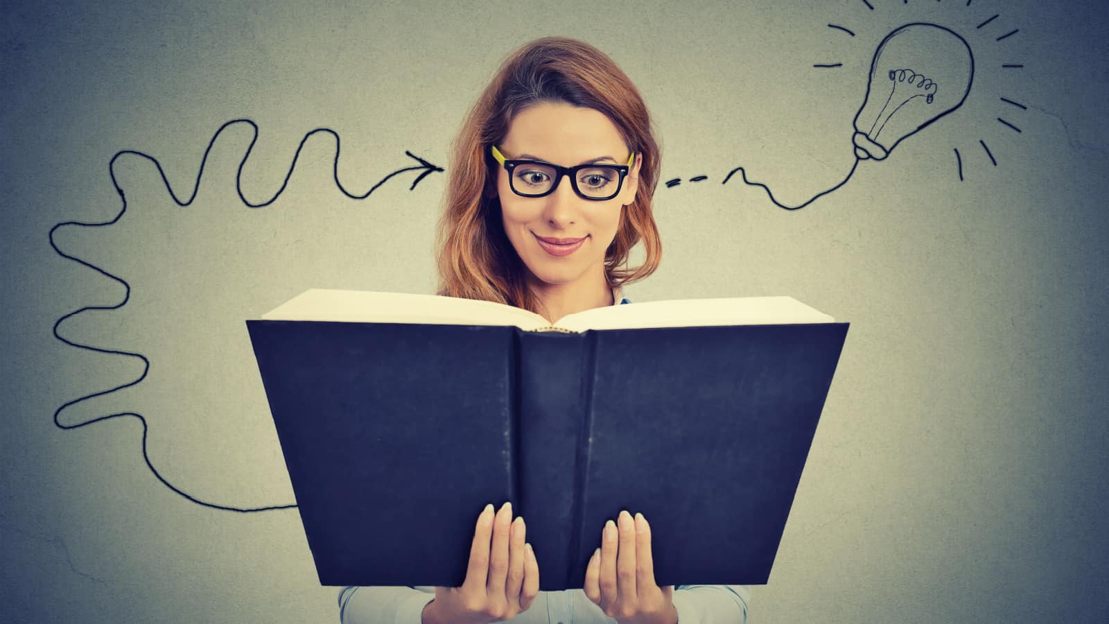 woman reading book. Understanding. Light bulb moment.