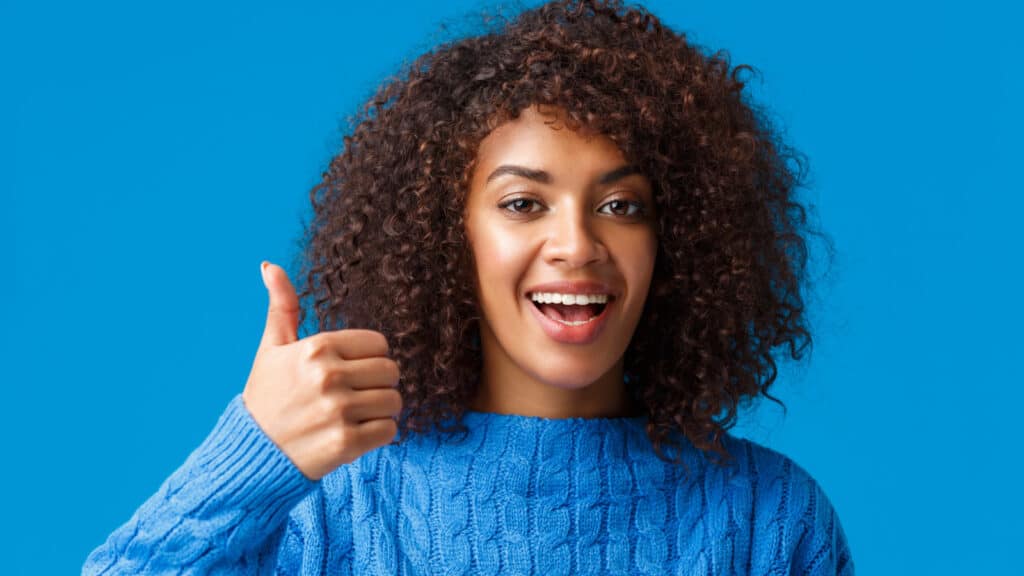 woman showing thumbs up.