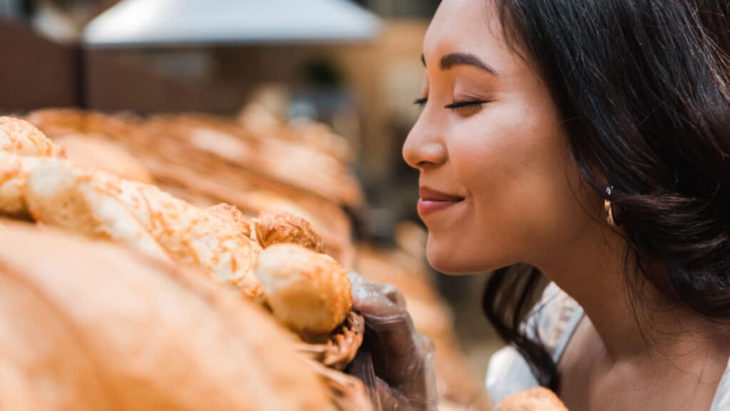 woman smelling fresh baked bread. 