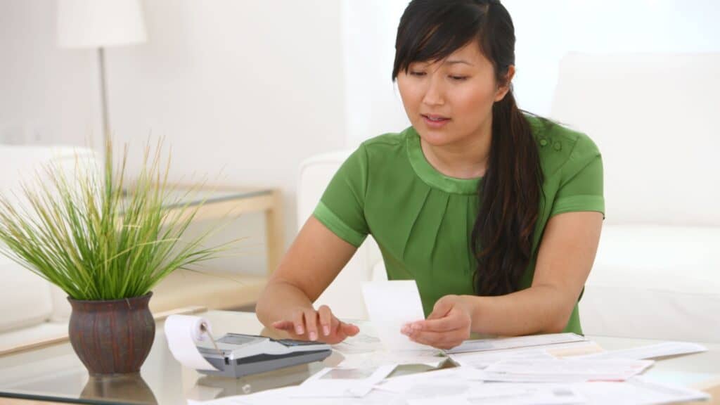 Asian woman with paperwork.