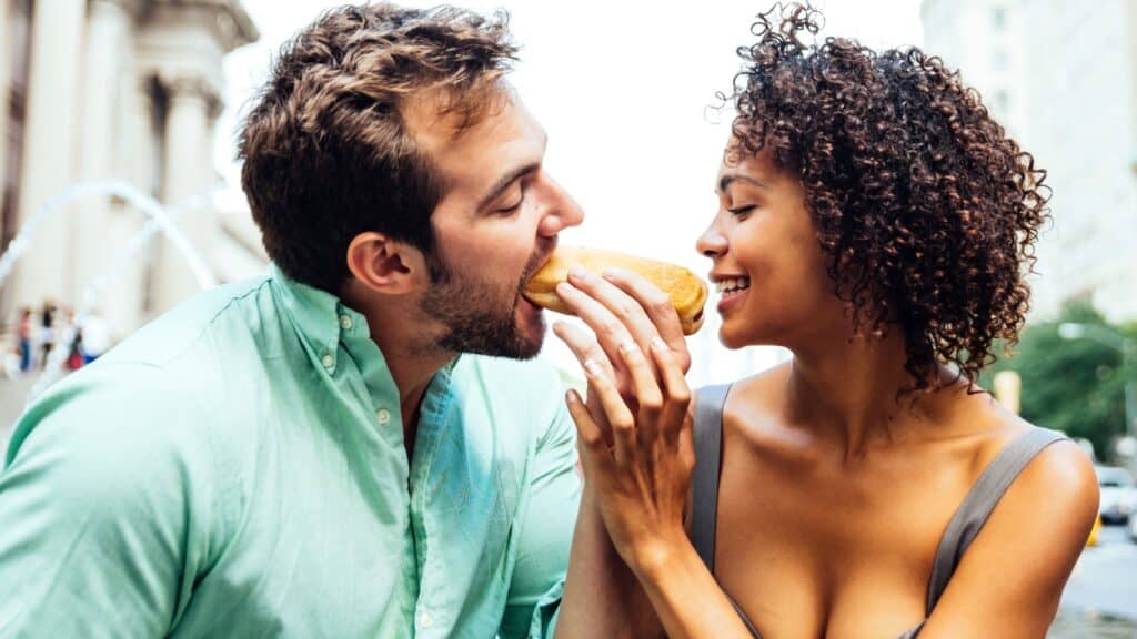 Couple enjoying a hot dog.