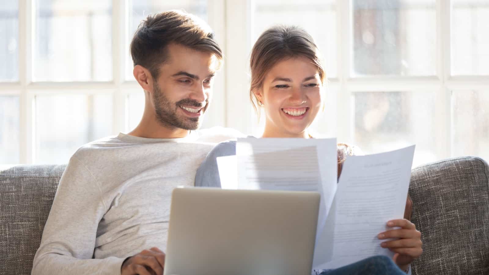 Couple with computer and paperwork.