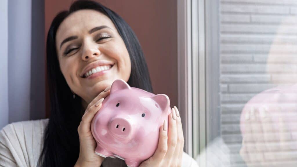 Financial independence. Woman holding piggy bank. 