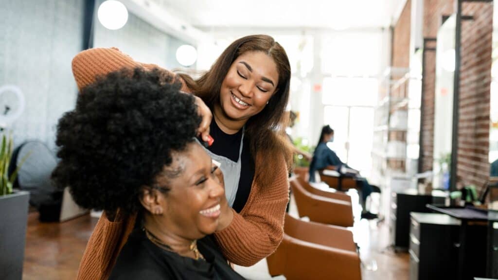 Hair stylist doing hair. 