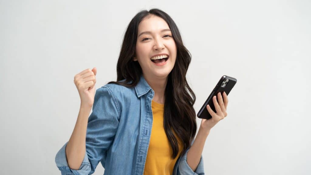 Happy woman using phone.