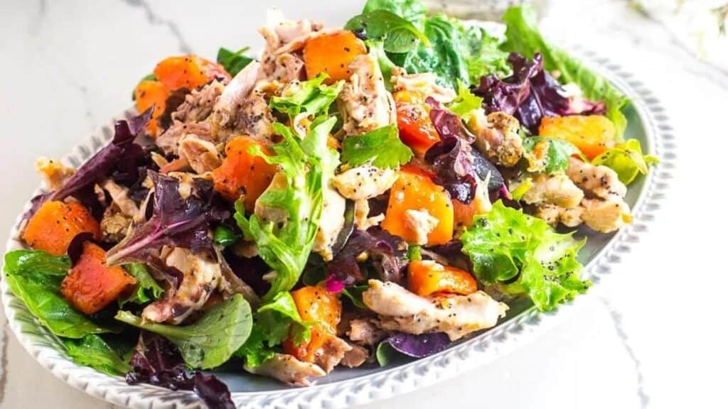 Low-FODMAP-Chicken-Papaya-Salad-with-Poppy-Seed-Dressing-on-oval-platter-marble-surface.
