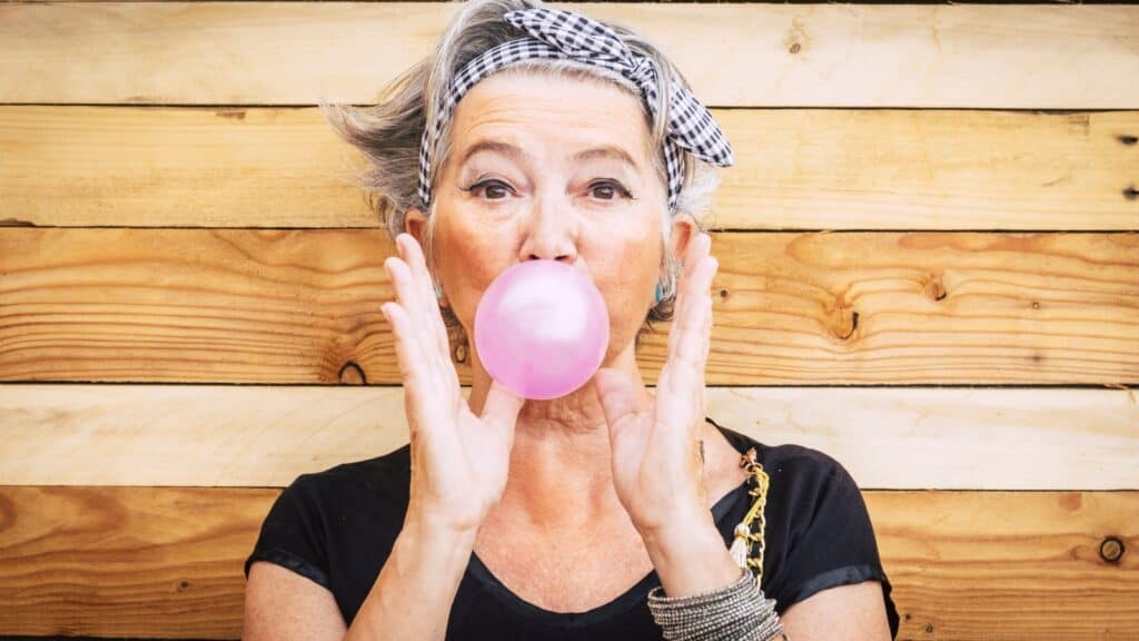 Older woman blowing bubbles. 