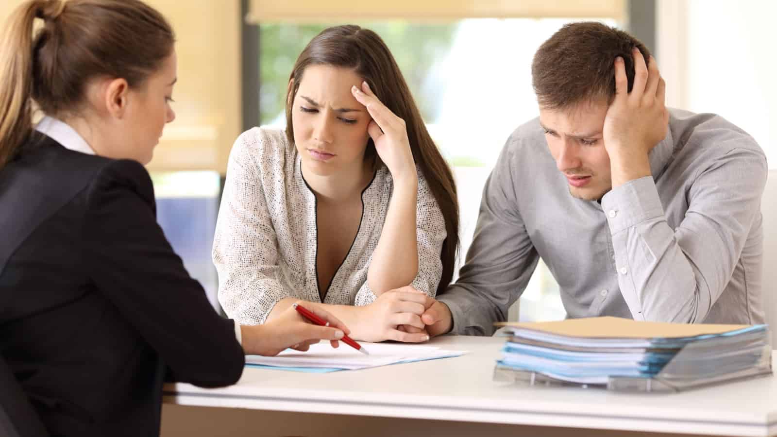 Overwhelmed couple with paperwork.