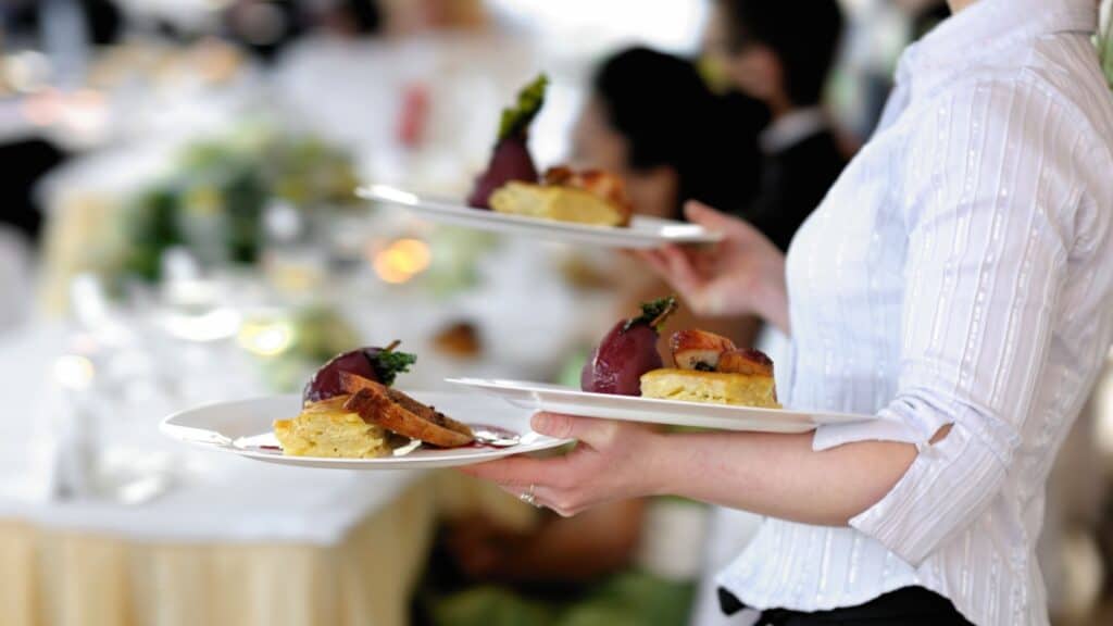 Waitress carrying plates.