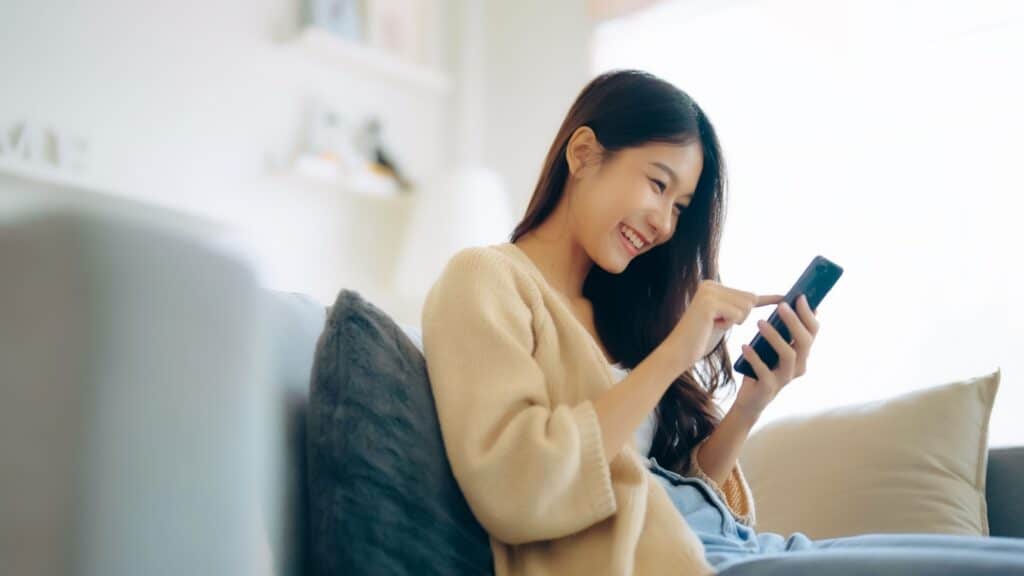 Young Asian woman using phone. 